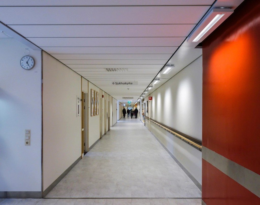 A long hospital corridor with doors along one side